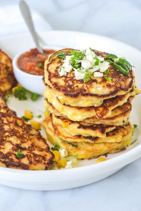 Soft in the middle with slightly crispy, buttery edges, these corn fritters with creamed corn are fast, easy to make and use simple pantry staples! Bursts of sweet corn and salty feta balance perfectly to make these fritters ideal for dinners, a light vegetarian lunch or lunchbox fillers that the whole family will love. But be sure to make a double batch, because they will disappear quickly! Creamed Corn Fritters Recipe, Creamed Corn Fritters, Cream Corn Fritters, Easy Creamed Corn, Savoury Pancakes, Corn Fritter, Corn Fritter Recipes, Fritters Recipe, Corn Fritters