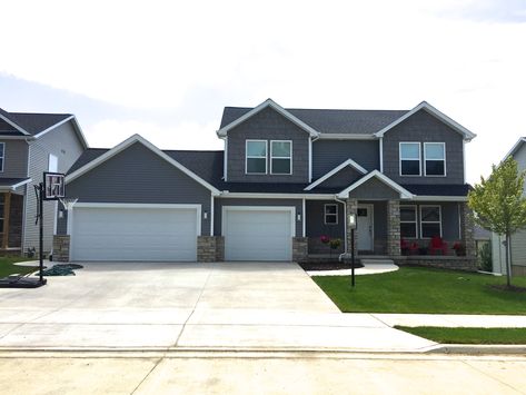 Mastic Deep granite gray siding with grey hand split shake and white trim with a Black roof in Edwards IL Grey Siding Black Trim, Mastic Vinyl Siding, Black Gutters, Mastic Siding, Gray Siding, Grey Siding, Gray House Exterior, Black Roof, Garage Addition