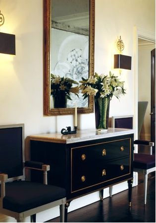 Gorgeous black wood marble top chest with gold accents! Love the upholstered black accent chairs flanking the chest and black leather box sconces! black brown gold ivory cream entrance foyer colors. ivory cream paint wall colors! Foyer Colors, Entrance Foyer Design, South Shore Decorating, Foyer Decorating, Entrance Foyer, Foyer Design, Mirror On The Wall, Wood And Marble, Restaurant Chairs