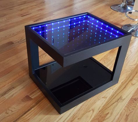 Modern and innovative this Black Coffee Table features impressive infinity blue LED light. Compliments any room, it is a really cool piece which will impress your friends (or dates). Works with 8 AA batteries (included) so no tripping cables connected to the outlet. You can place this table virtually anywhere in the room without the need to connect it to an outlet. It has its own ON/OFF switch conveniently place on the bottom, next to one of the legs, making it easily accessible in the dark. Thi Mood Lighting Living Room, Infinity Mirror Diy, Modern Industrial Coffee Table, Infinity Table, Mirror Illusion, Infinity Lights, Black Coffee Table, Led Bleu, Table Top Wine Rack