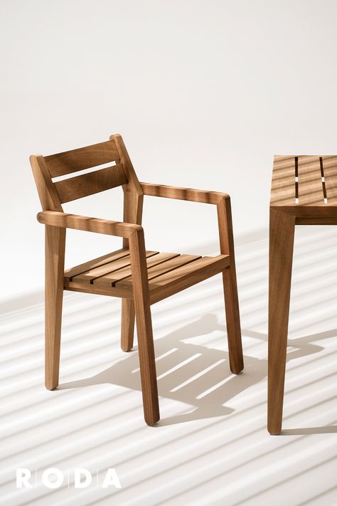 ZANIA is a collection of chairs and tables for outdoor use with a contemporary design that integrates naturally into contract spaces, such as Hotels or Restaurants, and in the most diverse contexts thanks to its small size and great functionality. Composed of a coffee table and a stackable chair with armrests, ZANIA is made of FSC certified Iroko wood, a warm-coloured, durable essence with extreme resistance to wet conditions. #rodadesign #beoutdoor #italianoutdoorlifestyle #design #outdoor Outdoor Wooden Table And Chairs, Wooden Chairs Outdoor, Wood Chairs Design, Small Chair Design, Wood Chairs Outdoor, Outdoor Wood Chairs, Outdoor Chair Design, Outdoor Reading Chair, Wooden Outdoor Chairs