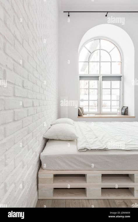 Download this stock image: White bedroom with double bed, brick wall and half circle window - JDMW09 from Alamy's library of millions of high resolution stock photos, illustrations and vectors. Bedroom With Double Bed, Half Circle Window, Circle Window, Atomic Design, Contemporary Chandelier, White Brick, Half Circle, Double Bed, White Bedroom