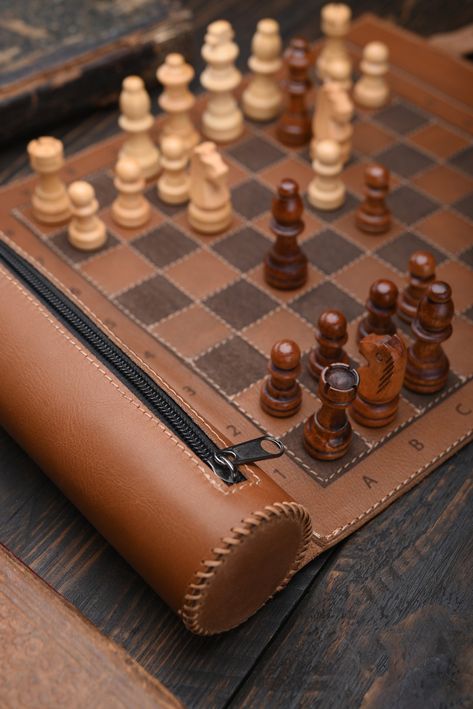 Leather Chess  Do you like to play chess and want to be able to do it even when you are on the go? A stylish leather roll for chess will give you such an opportunity. The set can be used at home, and at the same time it is compact enough to take with you on the road.    Advantages: * High-quality materials ensure a long service life. * Compact and lightweight, it is easy to store and light to transport. * Stylish design and excellent quality.    Product details: - 100% Handmade - Materials: genu Leather Chess Set, Leather Chess Board, Cool Chess Boards, Unique Chess Sets, Leather Products Ideas, Mini Chess Set, Themed Chess Sets, Chess Design, Handmade Chess Set