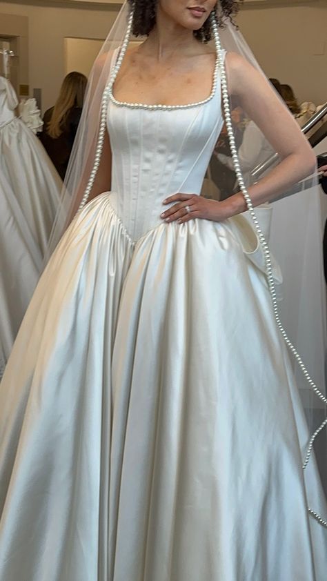 Square neck satin gown with drop waist and pearl lining (Designer: Pnina Tornai) Designer Vintage Wedding Dress, Pearl Colored Wedding Dress, Imperial Waist Wedding Dress, Square Neck Dress Aesthetic, Silk Wedding Dress With Pearls, Cowl Neck Corset Wedding Dress, Wedding Dress Dropped Waist, Long Sleeve Drop Waist Wedding Dress, Low Drop Waist Wedding Dress