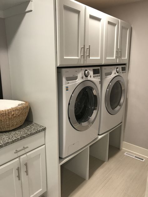 Laundry Room Basket Under Washer, High Washer And Dryer, Under Laundry Machine Storage, Laundry Room Ideas With Risers, Laundry Basket Storage Above Washer And Dryer, Laundry Room Storage Under Washer And Dryer, Under Laundry Storage, Laundry Basket Storage Under Washer, Laundry Room With Basket Storage