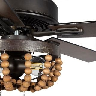 With an eclectic, Bohemian design and a sleek finish, this gorgeous ceiling fan is sure to stir things up. Two LED lights surrounded by artful wood beads make for a distinct aesthetic as this chic ceiling fan cools your home. The five blades are reversible, displaying your choice of rich barnwood or light driftwood finishes. Features: 5-blade ceiling fan Wooden beaded chandelier shade Brown and oil-rubbed bronze fixture finish Temperature-efficient with reversible blades Blades reverse from rich Boho Ceiling Fan, Wooden Ceiling Fans, Tropical Ceiling Fans, Wooden Bead Chandelier, Living Room Ceiling Fan, Ceiling Fan Bedroom, Creek House, Wooden Shades, Chandelier Led