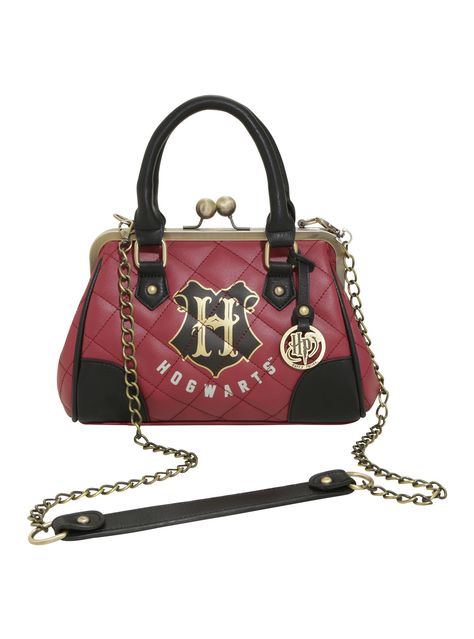 Maybe you shouldn't carry your wizarding needs in a cauldron when you're in the muggle world. It might raise some eyebrows. Keep it chic and undercover with this quilted burgundy satchel from Harry Potter with the Hogwarts crest and golden tone hardware.   9 1/2" x 7 1/2" x 3 1/2"  Polyurethane  Imported Harry Potter Handbags, Harry Potter Purse, Harry Potter Bag, Harry Potter Backpack, Harry Potter Quilt, Harry Potter Accessories, Harry Potter Merch, Bijoux Fil Aluminium, Harry Potter Merchandise