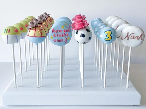 Toy Story Cake Pops 🩵 Customer asked for a muted color palette and “You’ve got a friend who’s 3” is just too cute of a theme! #toystorycakepops #toystory #cakepops #youvegotafriendinme #thirdbirthday #toystoryparty Pink Toy Story Cake, Toy Story Cakepops, Toy Story Treats, Astros Party, Toy Story Cake Pops, Peeps Cake, Dipped Treats, Cake Popsicles, Toy Story Baby