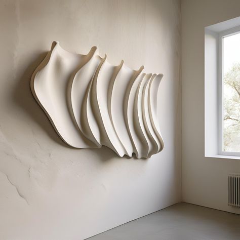 Plaster wall sculpture with a refined wavy shape, handcrafted in Milan. Each piece is carefully created on request, guaranteeing a 2 week wait from order to ensure the highest quality. Being entirely handmade, each sculpture is a unique and unrepeatable work, with distinctive details that make it different from all the others. Perfect for adding a touch of elegance and originality to any environment. Large Sculpture Art For Wall, Wall Textured Art Curves And Arches, 3 D Art Wall, Clay Figurine Wall, Figurative Clay Wall Art, Ceramic Wall Sculpture Artworks, Clay Wall Art Air Dry Sculptures & Statues, Concrete Wall Sculpture, Wall Art Living Room Sculptures