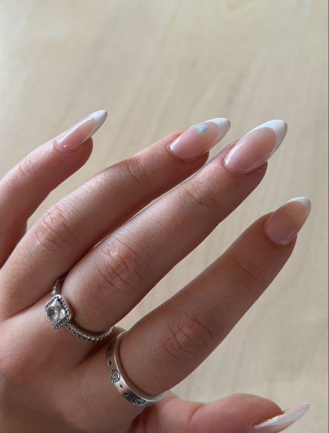 White French Nails With Blue Design, White French Tips With Blue Heart, French Tip Blue Heart, French Nails With Blue Heart, Blue Heart French Tip Nails, White Almond French Tip Nails With Design, Blue French Tip Nails With Heart, Almond Nails White French Tip, White French Tips With Design