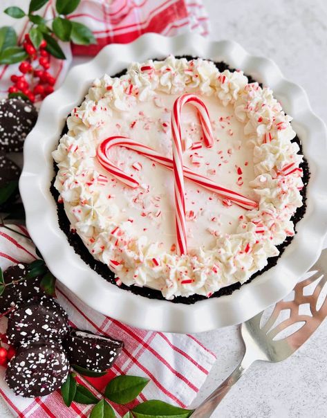 You'll love this no bake Candy Cane Pie that's made with cream cheese, real peppermint and crushed candy canes on an Oreo crust. It's the perfect peppermint pie recipe for the holiday season! Village Inn Candy Cane Pie Recipe, No Bake Candy Cane Pie, Peppermint Pie With Oreo Crust, Fun Christmas Desserts, Peppermint Pie Recipe, No Bake Candy, Peppermint Pie, Candy Cane Pie, Christmas Pies