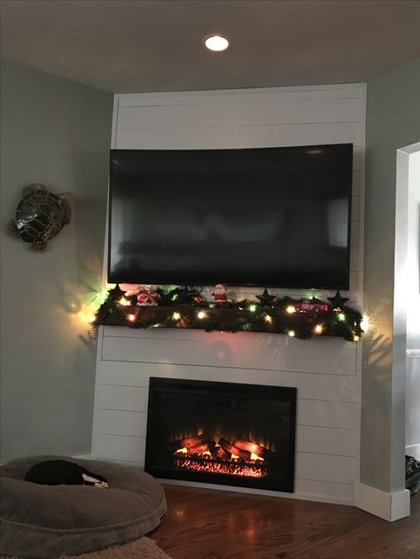 Shiplap corner fireplace with TV above. Corner Fireplace Tv Stand, Corner Fireplace Living Room, Corner Electric Fireplace, Corner Gas Fireplace, Cabin Fireplace, Shiplap Fireplace, Farmhouse Fireplace, Christmas Mantel Decorations, Fireplace Tv Stand