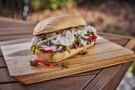 Check out this delicious recipe for Cheesesteak Sandwiches from Weber—the world's number one authority in grilling. Weber Griddle, Steak Package, Cheesesteak Sandwiches, Jet Tila, Pellet Grill Accessories, Weber Grills, Restaurant Steak, Sauteed Peppers And Onions, Sandwhich Recipes