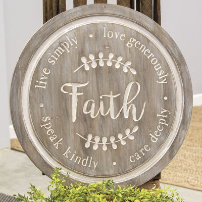 Distressed Faith Phrases Engraved Round Sign is a distressed wood sign with a circular shape and two d-ring hangers. It reads, Faith. Live simply. Love generously. Care deeply. Speak kindly in engraved lettering with the engraved graphic of two leaves and it measures 22 in diameter by .75 deep | Gracie Oaks Wall Décor, Wood in Brown / Gray | 22 H x 22 W x 0.75 D in | Wayfair | Home Decor Laser Engraved Signs, Wood Signs Round, Round Wood Signs, Speak Kindly, Faith Sign, Fall Leaf Wreaths, Distressed Wood Signs, Leaves Wreath, Round Wood Sign