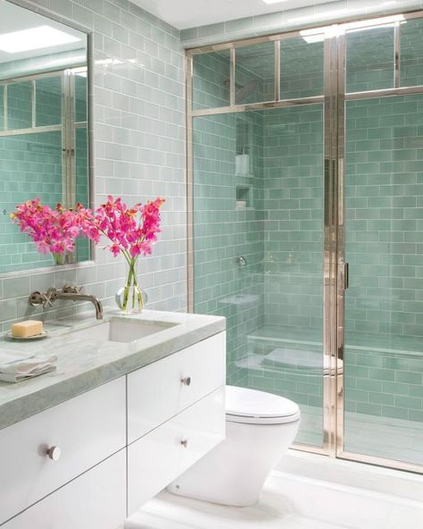 HGTV loves this bright, modern bathroom that features sea green glass subway wall tiles, white single under mounted sink vanity with green marble top, skylight, sleek modern glass shower enclosure and fixtures. Sea Green Bathrooms, Seafoam Green Bathroom, Glass Tile Bathroom, Condo Bathroom, Small Condo, Revere Pewter, Coastal Bathrooms, Bathroom Remodel Designs, Green Tile