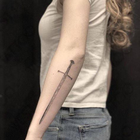 Sword tattoo on the left forearm. Nine Of Swords Tattoo, Broadsword Tattoo, Shield Tattoo Women, Aesthetic Forearm Tattoo, Dagger Forearm Tattoo, Anduril Tattoo, Excalibur Tattoo, Ogham Tattoo, Back Of Forearm Tattoo