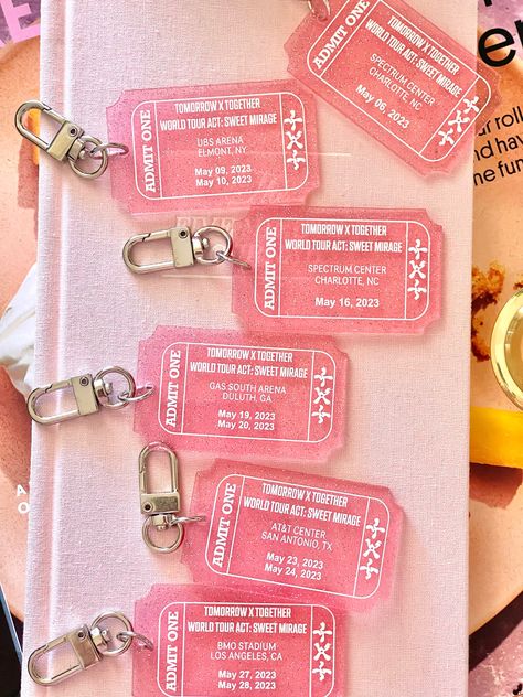 Get your hands on our limited edition Tomorrow Together concert tour keychain and show your love for one of your favs! Made with high-quality pink transparent glitter acrylic, this keychain features a stylish ticket design that matches their  concert theme colors. This keychain is the perfect accessory for any kpop fan, and it's a great way to commemorate their World Tour Act Sweet Mirage. It's also a great addition to any collection of kpop merchandise, and it's sure to be a conversation starter among your fellow Kpop enthusiasts. Order your concert tour keychain today while supplies last! Don't miss out on this opportunity to own a piece of history and show your support for the boys! Kpop Concert Ticket Design, Kpop Concert Accessories, Concert Merchandise Ideas, Kpop Event Ideas, Kpop Concert Ticket, Keychain Merchandise, Kpop Concert Freebies, Merchandise Ideas Products, Ticket Keychain