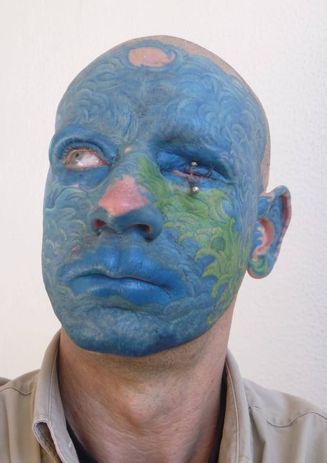 Blue And Green Ink Amazing Men Face Wave Tattoo #tuerto #pirsin 10 Tattoo, Leopard Tattoos, African Tattoo, Clown Tattoo, Facial Tattoos, Alien Tattoo, Blue Tattoo, Tattoo Fails, Asian Tattoos