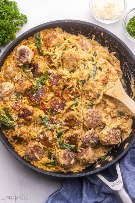 This Tuscan Chicken Meatballs and Orzo is an easy one pan meal the whole family loves! With sun dried tomatoes, garlic, Italian herbs, Parmesan, spinach and homemade chicken meatballs, it's loaded with flavor! #meatballs #recipe #dinner | one pan meal | one pot pasta | ground chicken recipe | easy dinner ideas | orzo recipe | marry me chicken | sun dried tomatoes | skillet meal | homemade meatballs Chicken Florentine Meatballs, Meatball Orzo Recipe, Medditeranean Meals, Chicken Meatballs And Orzo, Ground Chicken Recipes Easy, Meatballs And Orzo, Chicken Sun Dried Tomatoes, Ground Chicken Recipe, Ground Chicken Meatballs