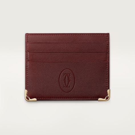 Burgundy calfskin 6-credit card wallet. Exterior: embossed double C logo, golden-finish metal corners, golden Cartier marking, six credit card pockets, one flat pocket. Dimensions: 85 mm high x 105 mm wide. This model may be made in Italy or Portugal. Cartier Wallet, Cartier Tank, Coin Holder, C Logo, Credit Card Wallet, Leather Wallet Mens, Business Card Holders, Small Wallet, Credit Card Holder