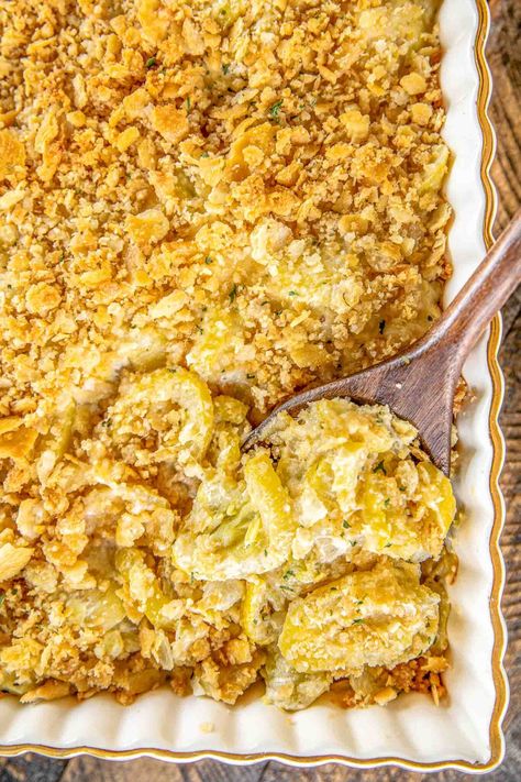 Cheesy Squash Casserole - a must for your holiday table!! Loaded with 3 types of cheeses - cheddar, Swiss and parmesan. Seriously delicious! Squash, onion, butter, eggs, sour cream, mayonnaise, cheddar, Swiss, thyme, salt, pepper, crushed Ritz crackers, and parmesan. NO cream of anything soup! Substitute crushed pork rinds for a gluten-free/low-carb/keto-friendly dish. Can make ahead of time and refrigerate overnight. #casserole #squash #sidedish #thanksgiving #christmas Old School Squash Casserole, Onion Butter, Yellow Squash Casserole, Thyme Salt, Yellow Squash Recipes, Cracker Toppings, Squash Casserole, Ritz Crackers, Fried Onions