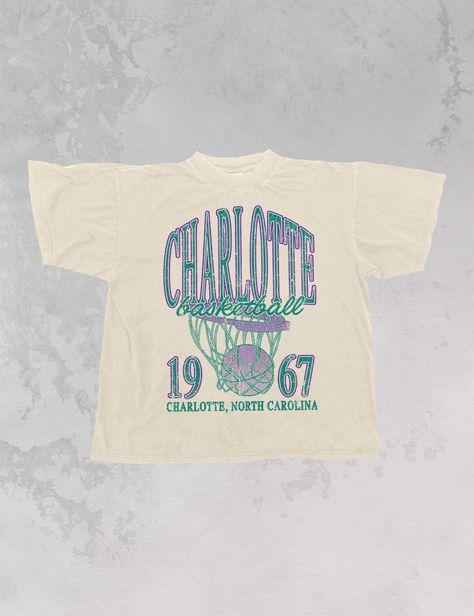 Show the love for your favorite team in this Charlotte, NC Basketball oversized tshirt that is inspired by vintage 90s N B A tshirts! - Features Charlotte Basketball across the top with a basketball hoop and 1967 with Charlotte, North Carolina underneath all in a purple and teal ink - Screen print transfer that is heat pressed onto each tshirt- Tshirt is a super soft vintage wash that gets softer after each wash- Oversized fit- Sizing translation: XS/S - L , S/M - XL , L/XL - 2XL , 2XL/3XL - 3XL * colors may vary slightly due to screens and filters * Retro Shirts Vintage Graphic Tees, Basketball Apparel, Charlotte Basketball, Basketball Logo, 90s Sports, Merch Design, Basketball Tees, Screen Print Transfer, Purple And Teal