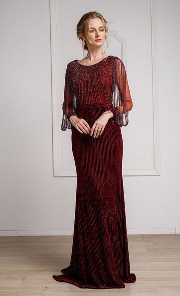 This gown is so stunning! It has intricate beading throughout the entire dress. It features a full neckline, a sheer back, and sheer long sleeves. The body of the gown is slim-fitting, velvet and fully beaded. The wrists of the sleeve feature the same material as the body of the gown. Coming off the shoulders, lines of sheer beads attach at the wrists, creating a beautiful dangling affect. The bodice is separated from the skirt by a strip of horizontal beading, creating a belt illusion. Long Sleeve Velvet Gown, Missy Dresses, Winter Ball, School Dance Dresses, Long Sleeve Velvet Dress, Velvet Gown, Red Gowns, Evening Formal, Mother Of The Bride Dress