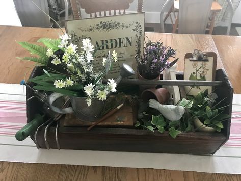 Garden Themed Table display out of old wooden toolbox. Wooden Tool Box Decor Table Centerpieces, Decorating With Old Wooden Boxes, Old Wooden Toolbox Ideas, Vintage Tool Box Decor Ideas, Wood Toolbox Decor Ideas, Spiritual Gardening, Wooden Decoration Ideas, Rustic Wooden Box Centerpiece, Decorating With Junk