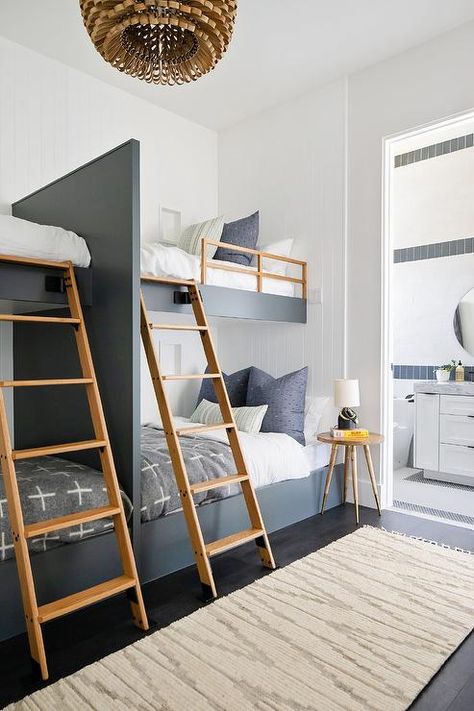 A light gray runner sits on a dark stained wood floor in front of black built-in bunk beds fitted with blond oak ladders and safety rails and fixed against a white beadboard trim. Black Bunk Beds, White Kids Room, Brooke Wagner, Style Me Pretty Living, Bunk Beds Built In, Built In Bunks, Bunk Rooms, Bunk Bed Designs, Bedding Inspiration