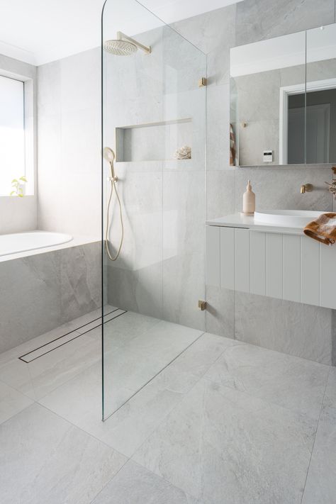 This luxe bathroom renovation by Elite Renovations features grey stone-look tiles ang grey finger mosaic. Just look at our new Vancouver tile in this bathroom splashback. The white paneled vanity works so well with the grey stone tiles. The clear glass shower wall allows light to bounce around while protecting the vanity from water spillage. The client also integrated a clever wall niche, a great extra bathroom storage idea to incorporate! Click on the image to visit our project gallery for more Light Grey Bathrooms, Grey Bathroom Tiles, Future Planning, Kentish Town, Coastal Bathroom, Classic Bathroom, Air Bnb, Chic Bathrooms, Bathroom Reno