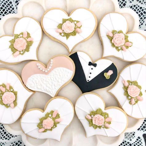 A white scalloped edge plate holding heart shaped cookies topped with pink roses. One of the cookies is decorated as a bridal gown bodice with oearl necklace and one looks like a groom’s tux jacket. Cookies For Engagement Party, Heart Wedding Cookies, Rehearsal Dinner Cookies, Engagement Cookies, Shaped Cookies, Heart Shaped Cookies, Heart Cookies, Wedding Cookies, Heart Wedding