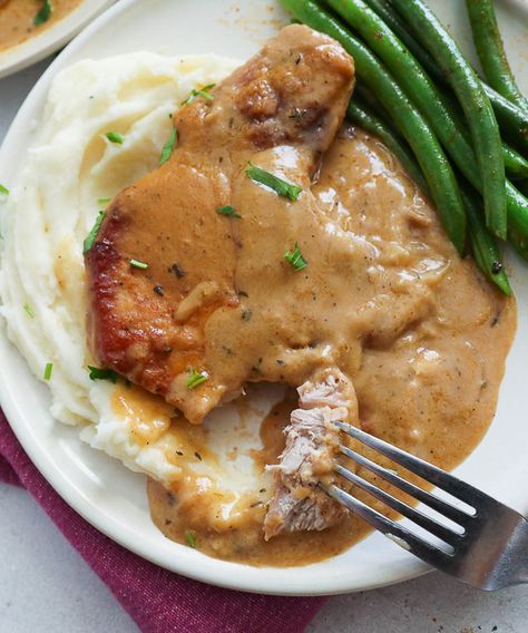 Easy Smothered Pork Chops - Immaculate Bites Easy Smothered Pork Chops, Smothered Pork Chops Recipe, Pork Chops And Gravy, Smothered Pork, Pork Chop Recipes Baked, Juicy Pork Chops, Smothered Pork Chops, Easy Pork, Chops Recipe