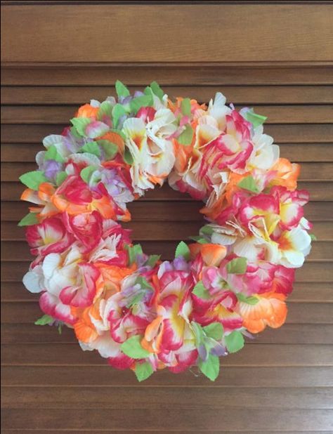 DIY: Get Festive With A Lei Wreath --  Add some spunk and color to your front door with this DIY Lei Wreath. Take A Lei Sign, Dollar Tree Flamingo Wreath, Barrel Garden Planters, Tropical Flower Wreath, Hawaiin Wreath, Hawaiian Wreath, Seaside Home Decor, Summer Diy Projects, Hawaiian Christmas