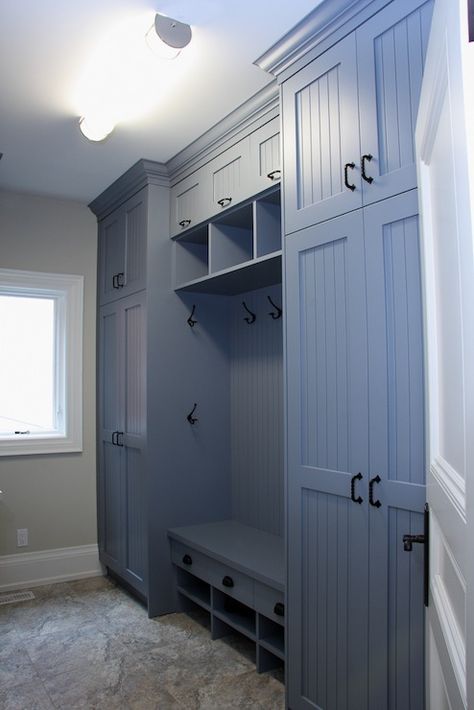 Blue mudroom with floor to ceiling cabinets & beadboard trim doors. Mudroom also includes a built-in bench, hooks, and stone floors. Beadboard Trim, Transitional Laundry Room, Vstupná Hala, Floor To Ceiling Cabinets, Mudroom Cabinets, Laundry Room/mud Room, Room Storage Diy, Mudroom Organization, Mudroom Laundry Room