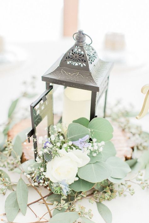 Abbott Manor Lantern and Wood Round. Client provided Battery operated votive sns flowers/greenery. Black Lantern Wedding, Lantern With Greenery, Babies Breath Flowers, Lantern Wedding, Lantern Centerpiece, Lantern Centerpiece Wedding, Breath Flowers, Lantern Centerpieces, Black Lantern