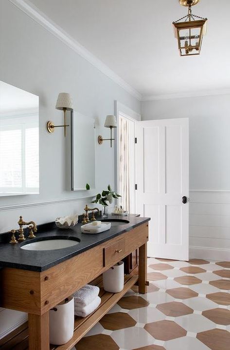 Oak double sink vanity topped with honed black stone countertops fitted with antique brass hook and spout faucets. Black Stone Countertops, Bathroom Lake House, Bathroom Cottage, House Lake, Cottage Bathroom, Lake Home, Black Vanity, White Marble Countertops, Double Sink Vanity