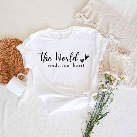 As an artist, I understand the struggles and joys that come with pursuing your passions. That's why I've created the "The World Needs Your HeART" t-shirt – a stylish and comfortable way to remind you of your worth and inspire you to keep creating! #WomensFashion #BellaCanvasTee #TShirtInspiration #TShirtDesign #TShirtQuotes #WomenEmpowerment #CreativeWomen #ArtistsOfPinterest #InspirationalQuotes #EmpoweredWomen #WomensStyle #TeeOfTheDay #FemaleArtists #EtsySeller #EtsyFinds #EtsyFashion Acdc Shirt, Bridesmaid Tshirts, Married Shirt, Honeymoon Shirts, Western Graphic Tees, Newly Married Couple, Bride Shirts, Newly Married, Bridesmaids Personalized