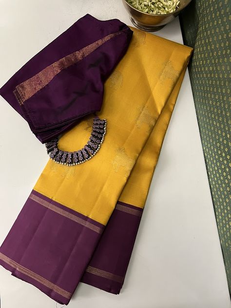 Pure kanchipuram silk saree woven in the korvai style , this saree is a signature Aavaranaa creation. The body has the kamdhenu motifs woven in pure zari, the border is kept simple but the pallu is richly woven in a traditional pattern with mythological figures and other smaller patterns like rudrakshams. This is a bright mustard yellow with deep mauve border. The blouse piece is plain border colour Mustard Yellow Color Combinations Outfits, Vadamalli Colour Silk Saree, Mustard Yellow Saree Blouse Combination, Saree Colour Combination Ideas, Sarees Colour Combinations, Mustard Colour Saree, Silk Saree Colour Combinations, Yellow Colour Saree, Pleats Techniques