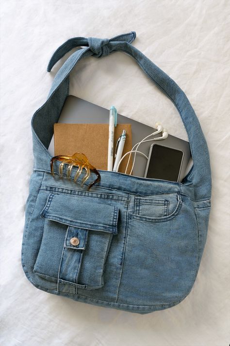 flatlay of denim bag with school supplies: laptop, notebook, stationery, phone and wired earphones Jeans Messenger Bag Diy, How To Sew A Bag From Old Jeans, Denim Bags Diy Recycling Old Jeans, Denim Sewing Ideas, Denim Thrift Flip, Jean Tote Bag Diy, Jean Sewing Projects, Upcycled Denim Bag, Jeans Tote Bag Diy