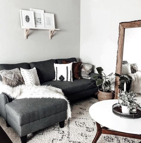 Dark gray couch decorated with pillows and a blanket, and a rug, mirror, and table to accent Slate Gray Couch, Dark Gray Couch, Charcoal Grey Couch, Grey Sofa Decor, Grey Couch Decor, Dark Grey Couch Living Room, Dark Grey Couches, Romantic Living Room, Gray Couch