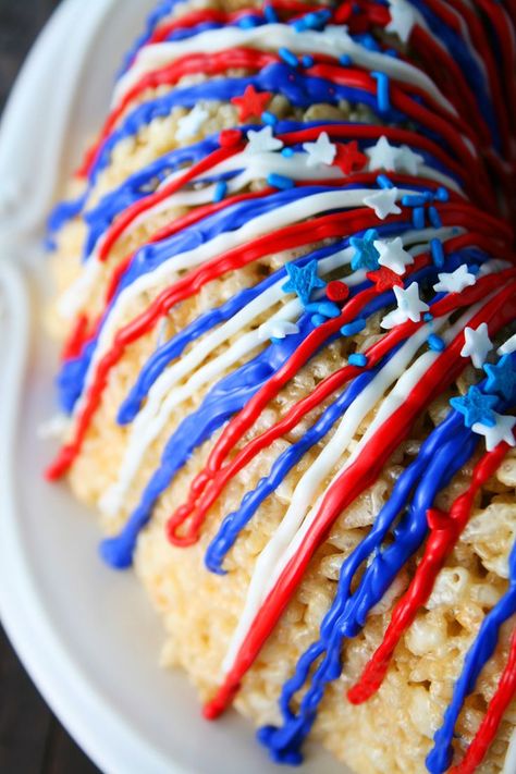 Rice Krispies Treats are pressed into a Bundt cake pan to form this Patriotic Rice Krispies Cake with red, white and blue candy melts drizzled on top. Recipes on MomLovesBaking.com #cake #fourthofjuly Rice Krispies Cake, Rice Krispie Cakes, Patriotic Desserts, July Recipes, Krispy Treats, Bundt Cake Pan, Rice Krispy, Crispy Treats, Rice Krispie Treats