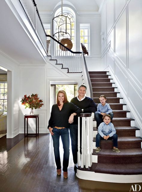 The couple and their two sons, Chase (top) and Lance, in the entrance hall; the light fixture is by the Urban Electric Co | archdigest.com درج السلم, Casa Clean, Grand Entryway, Geek Decor, Foyer Design, Hallway Ideas Entrance Interior Design, Westchester County, Hallway Ideas Colour, Hallway Ideas Entrance Narrow