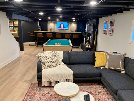 Exposed Ceiling Basement Ideas, Unfinished Basement Black Ceiling, Industrial Rustic Basement, Basement With Black Painted Ceiling, Spray Painted Basement Ceiling, Finished Basement With Black Ceiling, Industrial Basement Design, Basement For Teens, Spray Paint Basement Ceiling