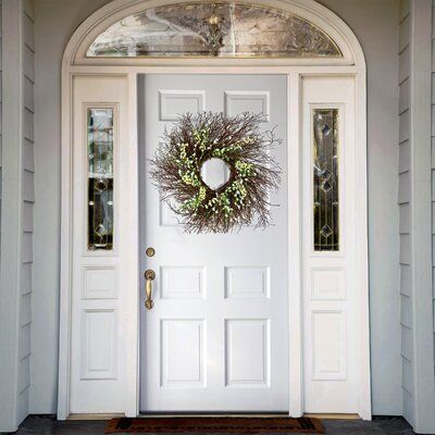 This wreath features a swirl of bristle twigs spiraling out from a woven branch ring base. It is decorated with white and cream-colored forsythia flowers atop long flowing stems. A mixing of berry clusters and leafy greens adds natural appeal and complimenting colors. Display this attractive decoration on doors, walls, and windows in indoor or covered outdoor locations. Wreath Color: White/Yellow | Primrue 24" Twig Wreath Wood / Twig in White / Yellow | 24 H x 24 W x 5 D in | Wayfair Forsythia Wreath, White Front Door, Exterior Entry Doors, Exterior Front Doors, Pretty Wreath, Painted Front Doors, Twig Wreath, Branch Ring, Leafy Greens