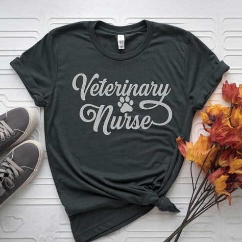 Check out the new “Veterinary Nurse” tee! Available in so many colors, there’s one for everyone. Head over to the Etsy shop to get yours today! #veterinarytechnician #vettechapparel #veterinarynursetee #veterinarynurse #vettechweekgift #vetmed #etsyseller #veterinaryetsy https://srmdesignbykatie.etsy.com/listing/1789947575 Veterinary Nurse, Vet Tech Week, Veterinary Assistant, Nurse Tshirt, Tech Week, Nurse Design, Vet Med, Veterinary Technician, Healthcare Design