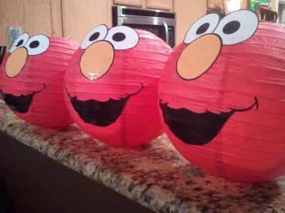 Red paper lanterns decorated with the face of Elmo.  See more Elmo birthday party ideas at www.one-stop-party-ideas.com Elmo Decorations, Elmo Birthday Party Ideas, Sesame Street Birthday Party Ideas Boy, Elmo Birthday Party Boy, Elmo First Birthday, Elmo Birthday Party, Sesame Street Birthday Party, Elmo Party, Sesame Street Party