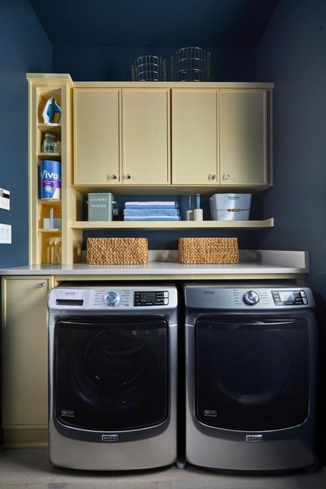 A rainy blue hue adds moody style to the laundry room walls and ceiling. This efficient space includes open and closed storage and top-notch appliances that make it easy to complete laundry and other common household chores. Mudd Room, Beach Dream House, Moody Style, Laundry Room Hacks, Cabinets To Go, Laundry Room Ideas Small Space, Tiny Laundry Rooms, Dream Laundry Room, Laundry Room Pictures