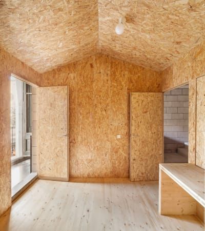 Josep Ferrando Architecture, Adrià Goula · House E+M · Divisare Plywood House, Osb Board, Gym Design Interior, Shed Makeover, Plywood Interior, Barn Storage, Wood Interior Design, Plywood Cabinets, Garage Interior