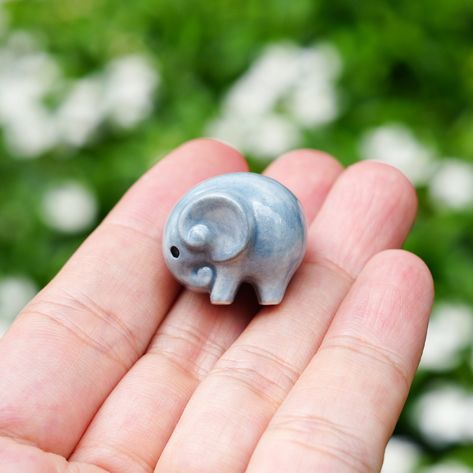 A tiny ceramic elephant figurine This elephant is crafted from fine porcelain, and meticulously hand painted in detail with great quality, highly collectible. He is the perfect for any miniature collector or elephant lover. Dimensions -- TINY GREY ELEPHANT FIGURINE: 0.7" (1.8 cm) - 0.75" (1.9 cm) -- TINY GREY ELEPHANT NECKLACE: Each charm is about 0.7" (1.8 cm) - 0.75" (1.9 cm) Chains are custom in 14 - 18 inches. -- Materials-- Pendant: Porcelain Clay, High Glaze The chain is made of high quali Elephant Clay, Elephant Ceramics, Clay Elephant, Tiny Elephant, Small Elephant, Elephant Jewelry, Miniature Figurine, Ceramic Elephant, Clay Diy Projects