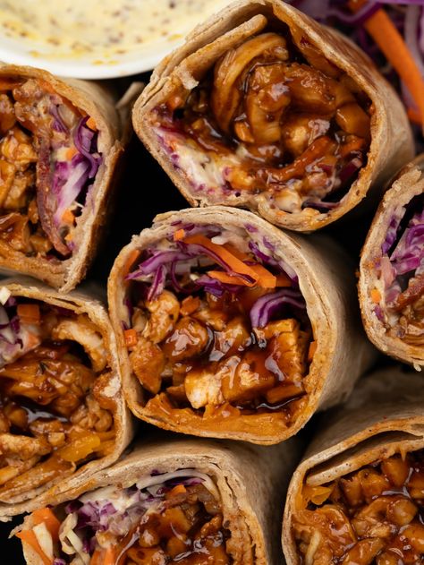 Chicken wrap filled with juicy made from scratch BBQ Chicken, crunchy veggies, cheese, and a mustard mayo sauce. These BBQ Chicken Wrap makes for a filling and nutritious meal that’s perfect to pack for lunch and a quick grab and go meal. Meet our favorite summer lunch!! Tender BBQ chicken breast, crunchy coleslaw, red onion,... Bbq Chicken Wraps Healthy, Mustard Mayo Sauce, Easy Chicken Wrap, Baked Bbq Chicken Recipes, Crunchy Coleslaw, Chicken Wraps Healthy, Chicken Thigh Seasoning, Grilled Chicken Wraps, Bbq Chicken Wraps